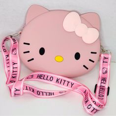 a hello kitty purse with a pink ribbon around it