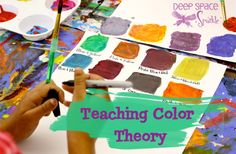 two hands are holding paintbrushes and painting the words teaching color theory