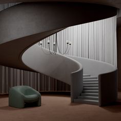 a spiral staircase next to a green chair