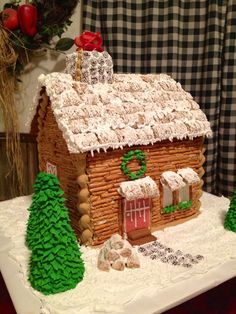 a gingerbread house decorated with icing and decorations