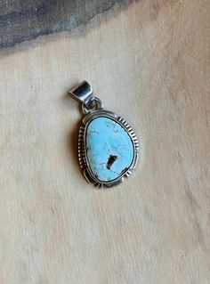 This vintage Small Navajo Sterling silver pendant features a rare high polish Dry Creek turquoise with its symbolic rare pastel blue natural color. Fine and delicate.  Swipe to see picture for pendant measurement, compare to quarter coin. Weight: 4.1 grams Signed: JF Sterling Dry Creek Turquoise comes from a small Turquoise mine outside of Austin, Nevada in Lander County. This mine was previously known for its sky blue to medium blue webbed turquoise. Dry Creek Turquoise has gained much popularity over the years with its creamy pale blue coloring and golden to cocoa brown matrix. This color of Turquoise was rarely used in Turquoise Jewelry before the late 1990s. The color is a pastel blue much like the color of Larimar, only high grade Dry Creek Turquoise has beautiful light brown, golden Artisan Blue Turquoise Necklace Untreated, Blue Engraved Turquoise Pendant Necklace, Untreated Oval Blue Turquoise Necklace, Blue Turquoise Pendant Necklace With Engraving, Rustic Blue Jewelry With Natural Stones, Rustic Blue Sterling Silver Jewelry, Bohemian Blue Untreated Necklaces, Rustic Silver Turquoise Necklace As Gift, Rustic Silver Turquoise Necklace For Gift