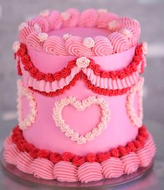 a pink and red cake with hearts on it