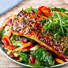 a white plate topped with salmon and vegetables