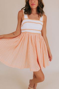 Get your style game on point with our Orange You Glad Dress! This mini dress features a unique combination of an off white embroidered bodice and a bright coral orange gingham skirt. With orange scalloped details and functional pockets, this dress is perfect for a fun, sunny day out. And don't forget the square neckline and sleeveless design for a touch of effortless chicness. Stay trendy, stay comfortable! Details Off white embroidered bodice Bright coral orange gingham skirt Orange scalloped d Orange Sundress, Nursing Friendly Dress, Orange Gingham, Orange Mini Dress, Plus Jumpsuit, Gingham Skirt, Embroidered Bodice, Orange You Glad, Orange Coral