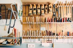 many different tools are hanging on the wall