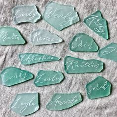 some green glass pieces with names on them