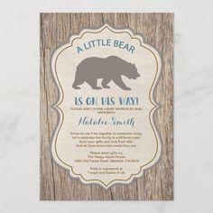 a little bear is on his way baby shower card with wood grain and blue lettering