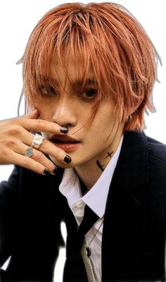 a man with red hair and piercings on his fingers