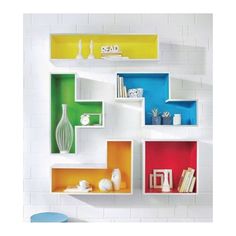 an assortment of colorful shelves on the wall