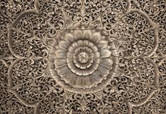 an intricately carved wood panel with flowers and leaves on it's surface, in the shape of a flower ornament