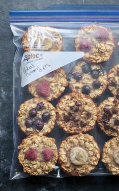 a plastic bag filled with muffins covered in granola and fruit toppings