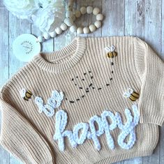 a sweater with the words happy written on it