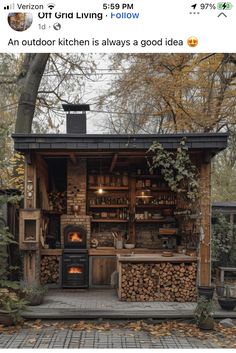 an outdoor kitchen is made out of wood and has firewood stacked on the outside