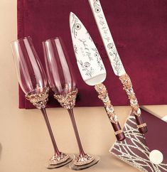 three wine glasses and a knife on a table