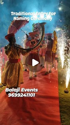 people in traditional garb dancing on a red carpet with fireworks behind them and the words traditional entry for naming ceremony