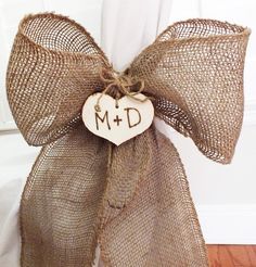 a burlap bag with a wooden heart that says m + d on it