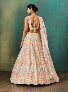 Editor's Note Featuring an ivory lehenga with pastel multicolor floral applique all over with highlights of sequin, pipes and cutdana. It has a matching blouse and embroidered border soft organza dupatta. Fabric: Dupion silk, net, Lining: shantoon Color: Ivory Component: Lehenga, blouse and dupatta Ocassion: Wedding Care: Dry Clean Only About the Designer Label Aneesh Agarwaal offers regal Indian designs developed with a modern asthetic for the discerning Indian Woman. Pastel Multicolor Lehenga, Aneesh Agarwaal, Organza Applique, Ivory Lehenga, Stitching Tutorial, Applique Flower, Indian Designs, Floral Lehenga, Indian Woman