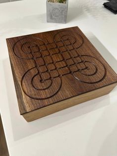 a wooden box sitting on top of a white table