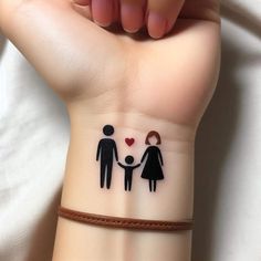 a couple holding hands with a heart tattoo on their wrist