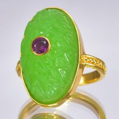 18K GOLD VERMEIL over STERLING SILVER, CARVED GREEN CHALCEDONY & RHODOLITE LOTUS RING             Item # : 184  0151           Type of ring : 18K Gold Vermeil over solid 925 Sterling Silver ring set with a large oval carved forest green Chalcedony Lotus flower with a bezel-set Rhodolite Garnet gemstone inlay.       Type of carving : Lotus flower in deep relief       Design of ring : Magnificent 18K Gold Vermeil over 925 Sterling Silver bezel-set with a stunning carved Lotus flower design oval shaped translucent green Calcedony with a genuine natural Rhodolite gemstone inlay.       Material : Natural forest green Chalcedony, pinkish red Rhodolite Garnet gemstone and 18K Gold Vermeil over genuine solid Sterling Silver ~ 18K gold-plated 3-microns.       Plating : Very thick and durable ~ 3-mi Lotus 7, Natural Forest, Lotus Ring, Nigeria Africa, Lotus Flower Design, Relief Design, Deep Relief, Sterling Silver Rings Set, Pinkish Red