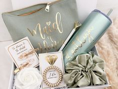 a gift box filled with personalized items including a coffee cup, card and jewelry