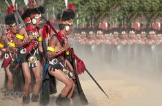 an image of some people that are in the sand with swords and masks on their heads