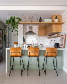 two wooden chairs sitting in front of a kitchen counter