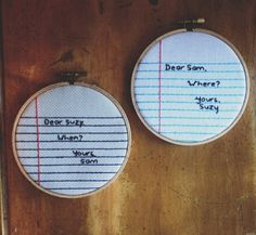 two cross stitch hoops with writing on them, one says dear son where? and the other says what's your story