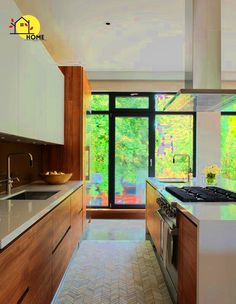 a kitchen with a stove top oven sitting next to a window filled with lots of windows