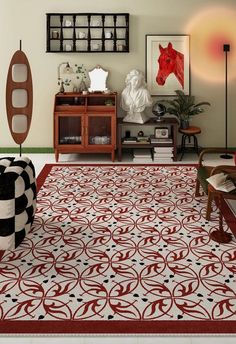 a living room with red and white rugs on the floor next to a chair