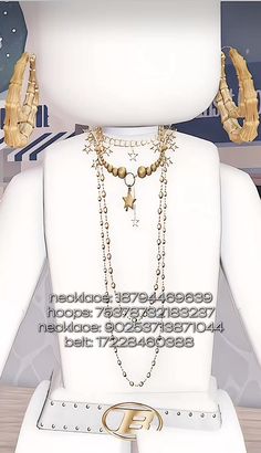 a white mannequin with gold jewelry on it's neck and two hands