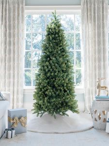 a living room with a christmas tree in the corner