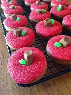 there are many red donuts on the cooling rack