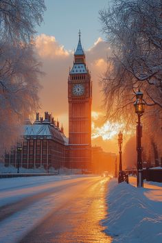 the big ben clock tower towering over the city of london covered in snow at sunset