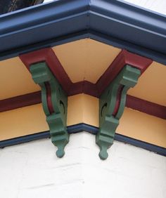 the corner of a building with two green and red corbets on it's sides