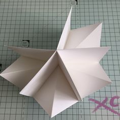 an origami flower on a cutting board