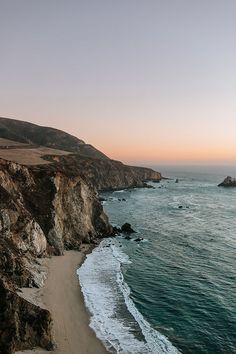 the beach is next to an ocean cliff