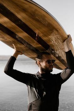 a man holding a surfboard over his head