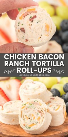 chicken bacon ranch tortilla roll - ups on a cutting board with fruit in the background