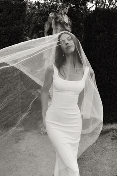 black and white photograph of woman in dress with veil