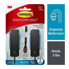 two black and white bathroom accessories with the packaging on it's side, including an iron