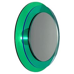 a round mirror with green trim around it