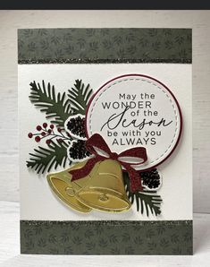 a handmade christmas card with a bell and pine cones on it, which reads may the wonder of the season be with you always