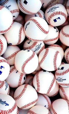 many white baseballs are piled up together