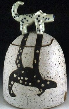 a white and black vase with a dalmatian dog on it