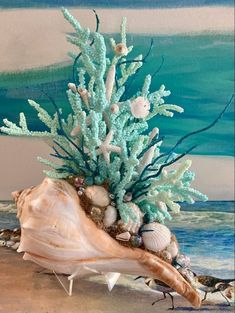 a blue coral and seaweed arrangement in a seashell