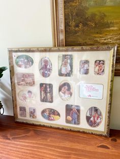 a wooden table topped with pictures and a potted plant