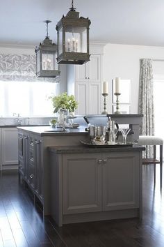 the kitchen is clean and ready to be used for cooking or dining, with two hanging lights above the island