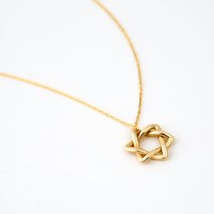 ❧ Product Overview and Key Features  Crafted with precision, this delicate Star of David Necklace in 14K Solid Gold is an emblem of faith and fashion. Perfect for the modern woman, this dainty  Jewish Star necklace is a unique blend of spiritual symbolism and contemporary style. Made from 14k yellow gold, this delicate star of David charm doubles as a star necklace, making it a versatile addition to your jewelry collection. *Material & Color Options: 14k Yellow Gold, 14k White Gold, 14k Rose Gol Necklaces Star, Jewish Star Necklace, Necklaces Collection, Star Of David Necklace, Jewish Star, Timeless Symbol, 14k Yellow Gold Necklace, Star Of David Pendant, Solid Gold Necklace