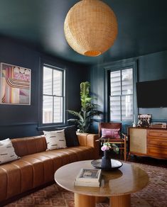 a living room filled with furniture and a flat screen tv mounted to the side of a wall